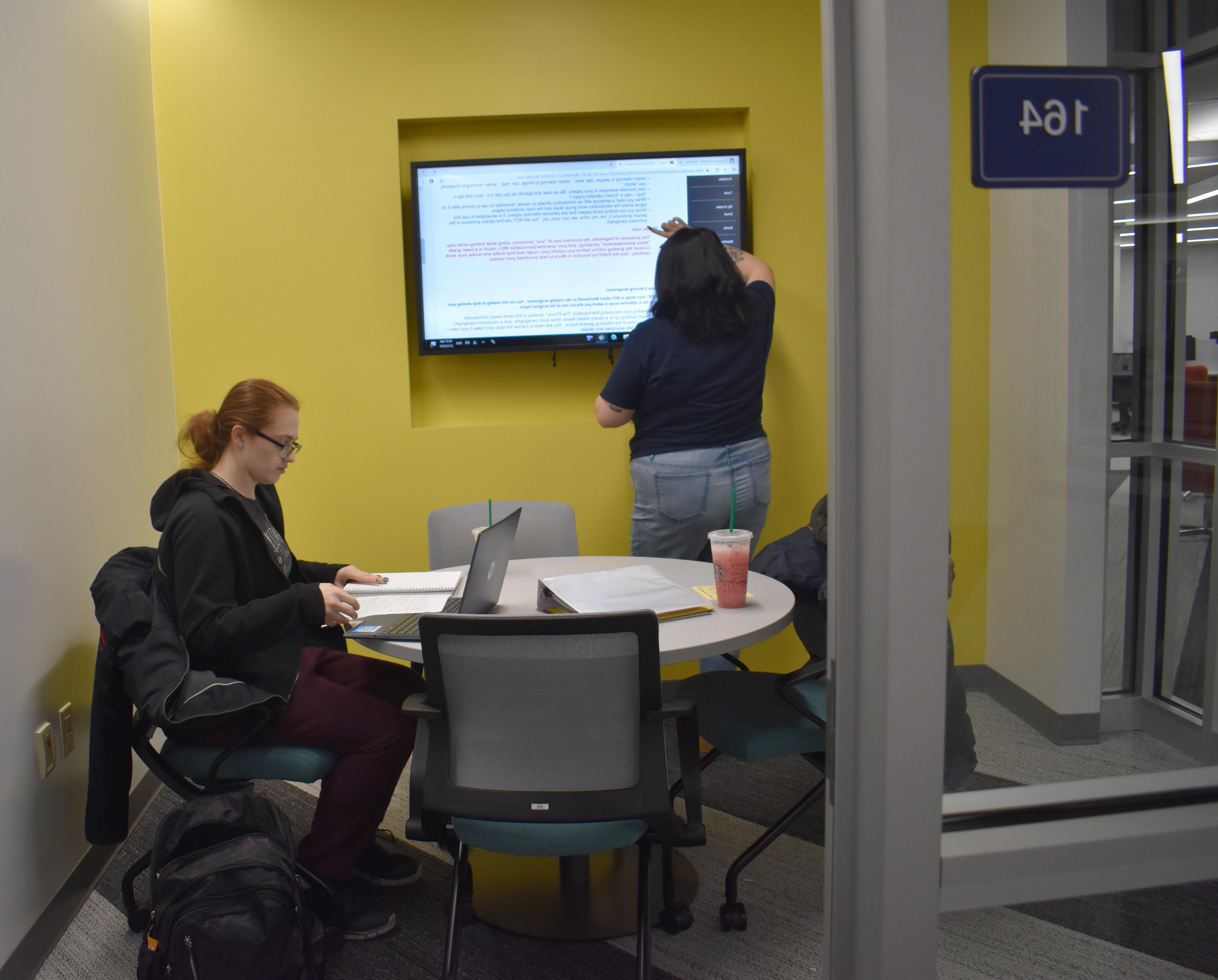 Two students sharing a study area in Shake Resource Center
