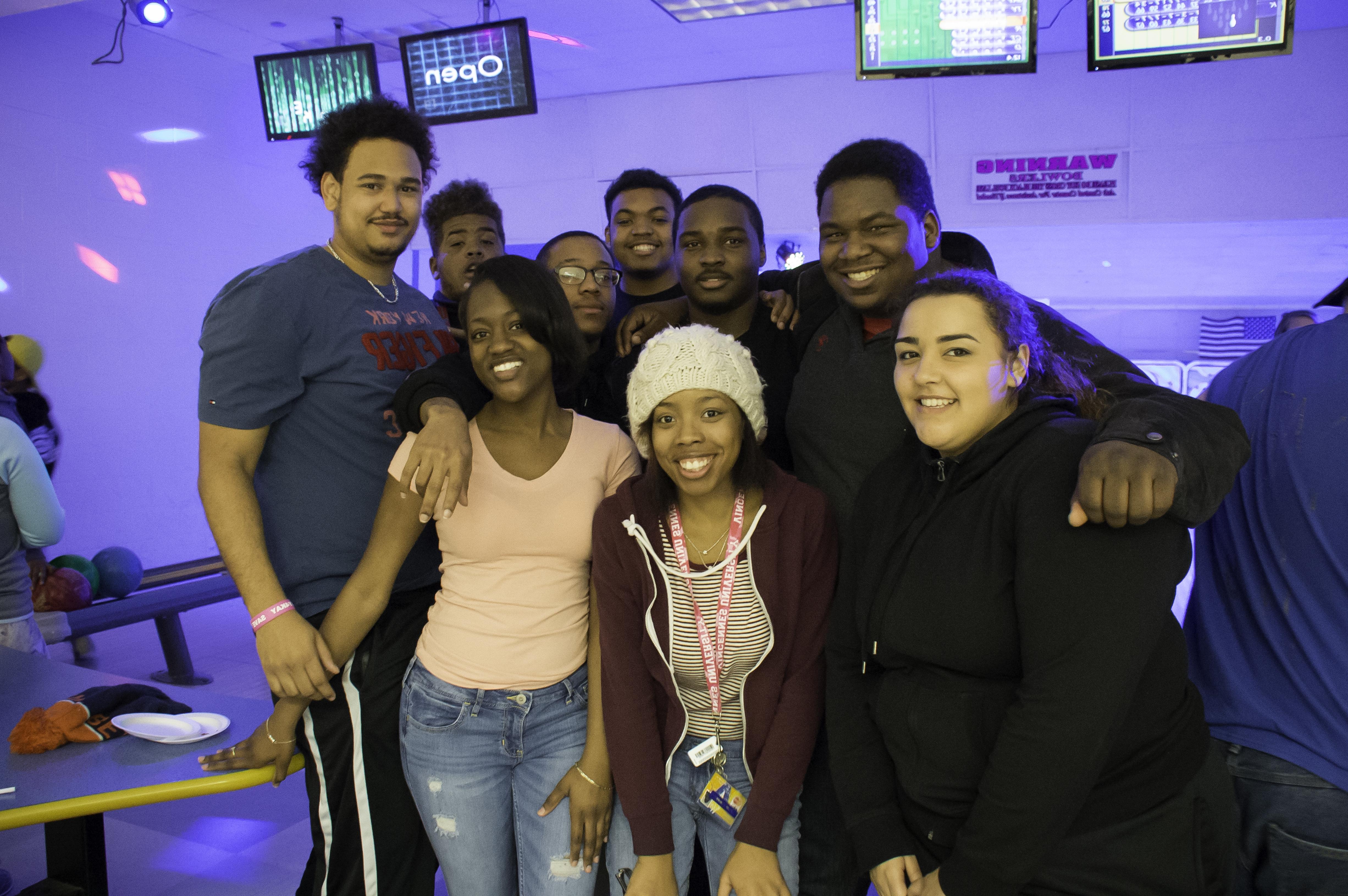 A group of students posing for a photo at the bowling alley