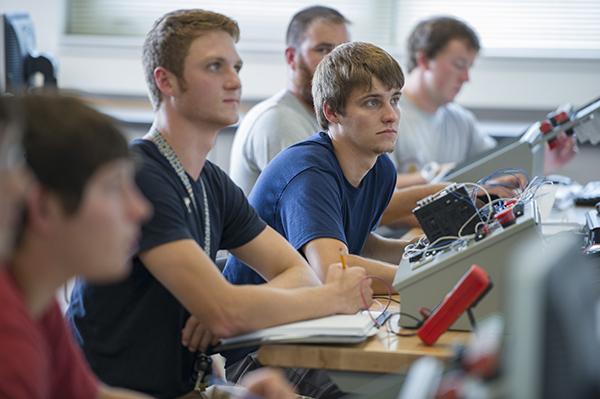 A group of students taking notes during an electronics class