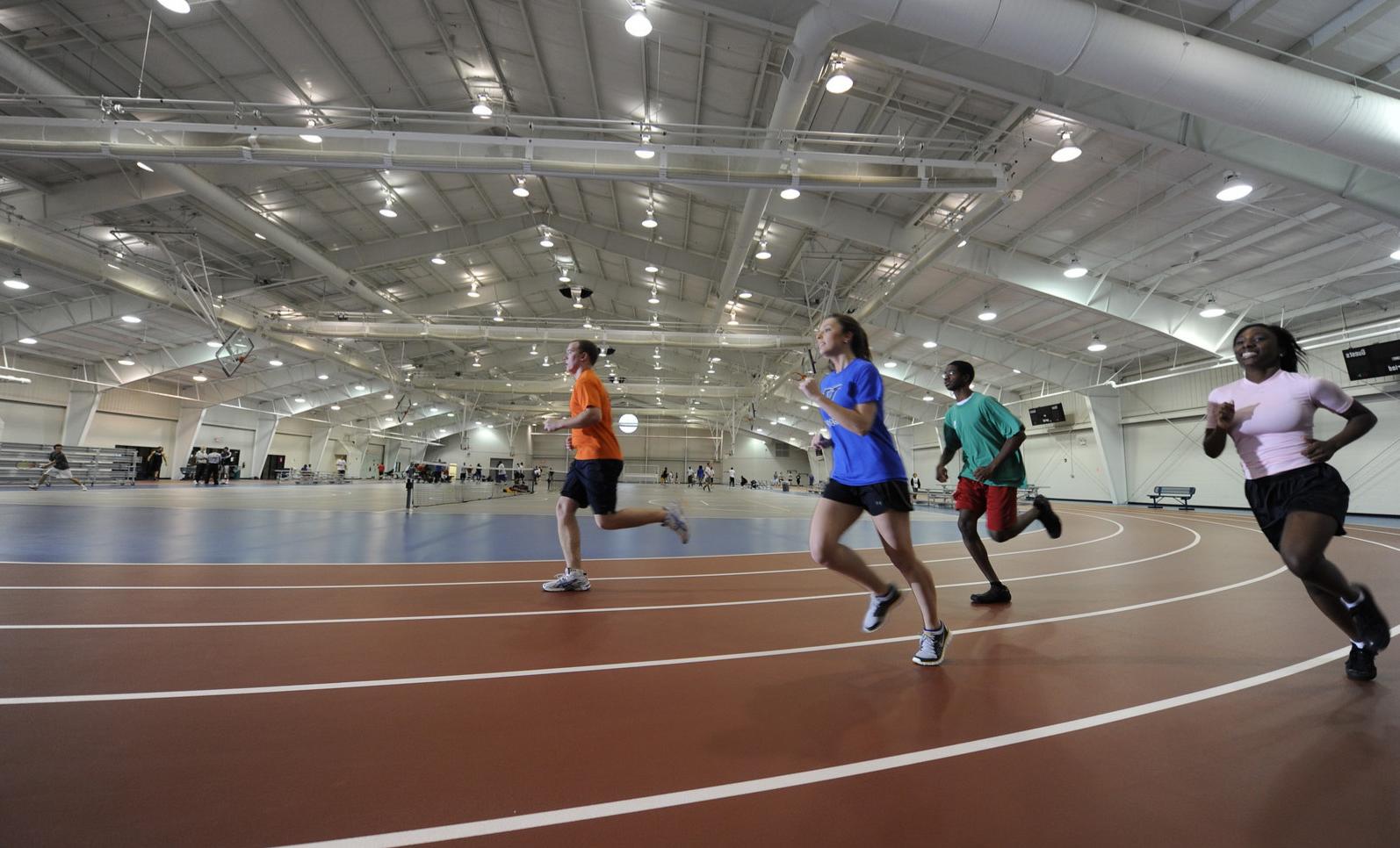 Students running around an indoor track