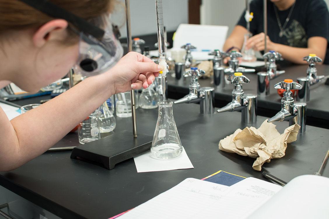 A student filling a flask during a lab