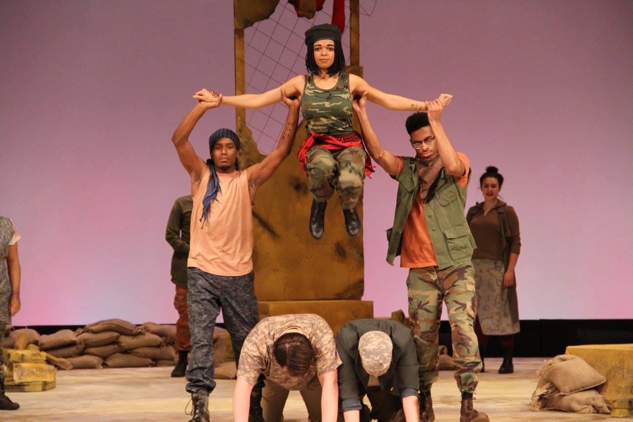 Two male theatre majors lifting a female theatre major up by her arms
