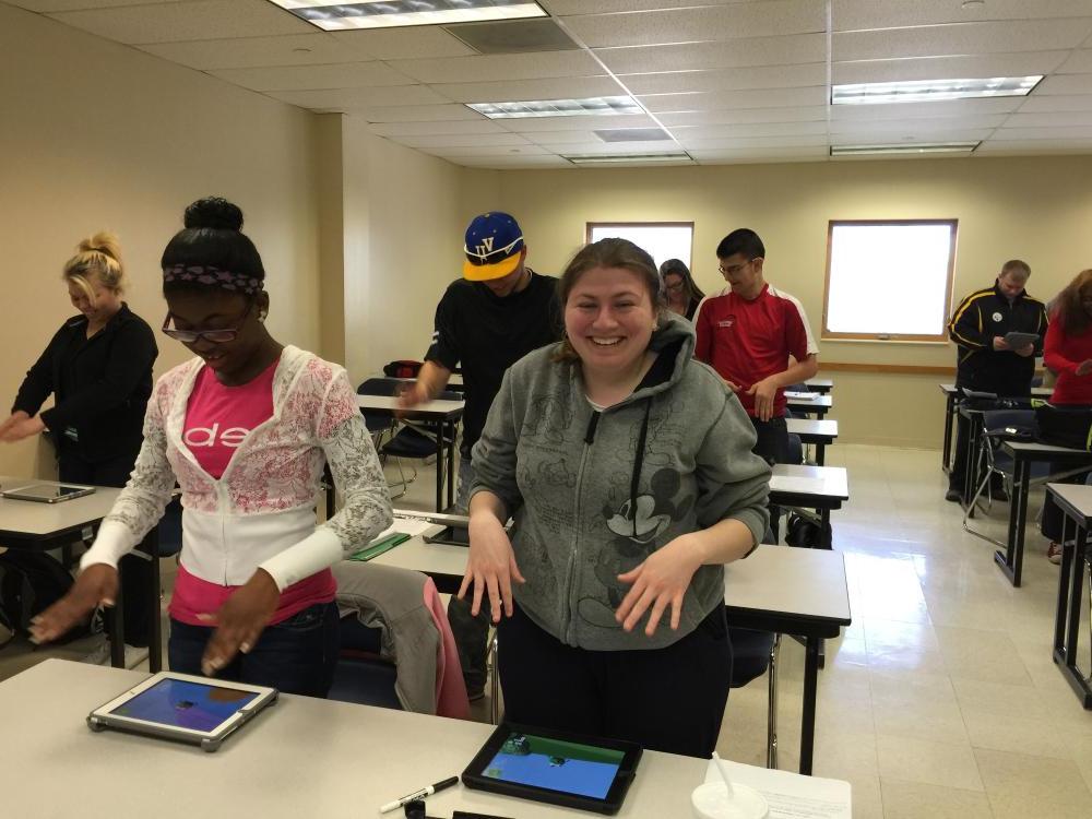 Students in a classroom playing games on iPads