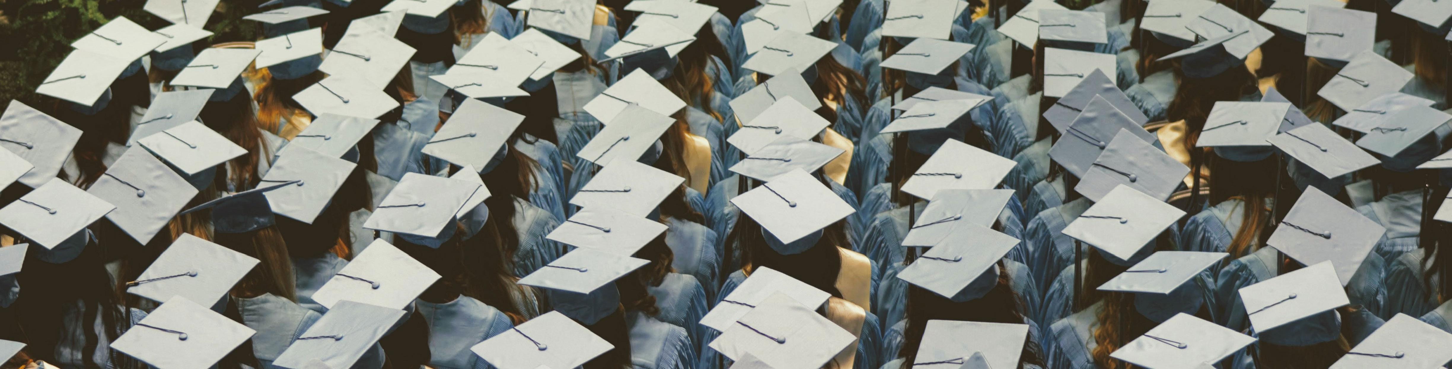 A large group of students wearing caps and gowns for graduation